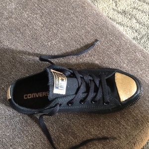 Black and gold low top converse